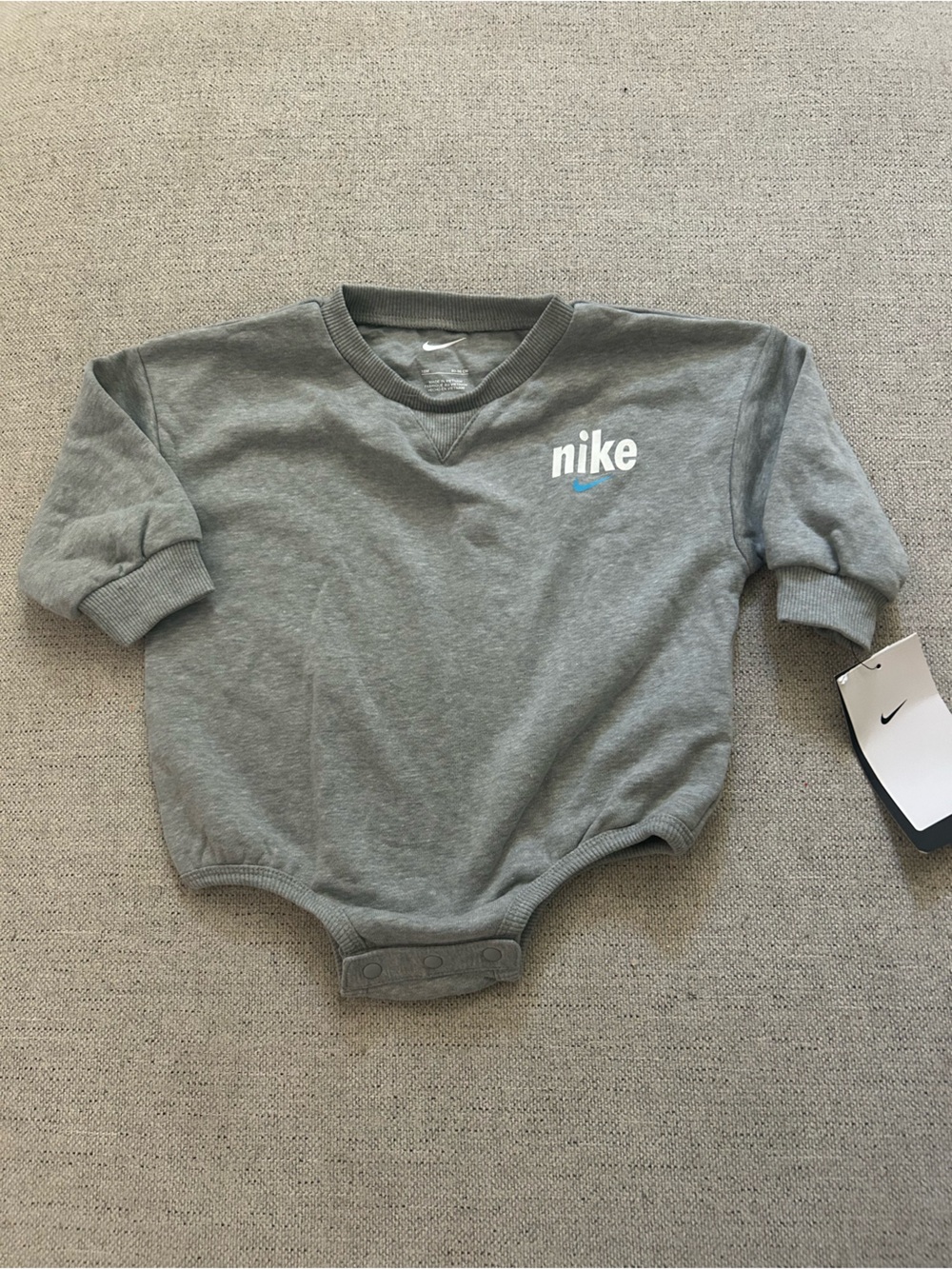 Nike Grey Baby Sweatshirt Bodysuit with White Logo and Blue Swoosh